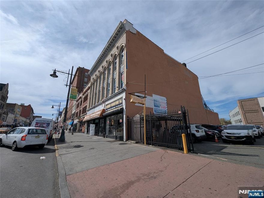 Rare opportunity to acquire a stabilized, income-producing commercial building in the heart of Paterson. Positioned on highly trafficked Market Street, this 3-story masonry asset offers approximately 13,107 SF of prime downtown real estate with immediate cash flow and long-term upside. The property features a leased retail storefront on the first floor (approx. 6,500 SF) and a leased office space on the third floor (approx. 3,500 SF), delivering strong in-place income. The second floor (approx. 3,500 SF) provides clear value-add potential for repositioning or future development. The property also includes rear land behind the building, offering additional expansion or build-out potential (subject to approvals). Located within the B-4 Central Business District zone, the property supports a variety of commercial and mixed-use uses. Based on zoning parameters and preliminary development concepts, there may be potential for residential conversion, with conceptual estimates ranging from approximately 40 to 90 units, subject to architectural design and full municipal approvals. Buyer to conduct independent due diligence with the City of Paterson. Surrounded by redevelopment, transit access, and established commercial activity, this asset offers multiple strategies: stable hold, expansion, repositioning, or long-term redevelopment.