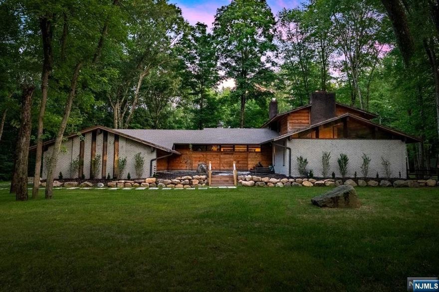 Architecturally significant private residence in DREAM location in Saddle River, sitting at the end of a quiet cul-de-sac surrounded by multi-million dollar homes. This contemporary & expanded ranch style home is extremely spacious w. custom upgrades throughout. Expansive 1st floor with amazing living saces. Huge newly renovated kitchen w. double islands & SubZero/ Wolf appliances, amazing Great Room with pizza oven, custom bar, & vaulted ceilings. Banquet sized dining room plus another large family room. Amazing layout for entertaining. Multiple rooms have access to the huge deck overlooking the breathtaking property w. huge resort style pool. Private Primary Oasis on top level w. massive WIC & primary bathroom. Finished Basement w. gym, rec room, office space. Bonus 2 story structure in rear of property offers endless potential - guest house, car collection, horse stable, pool cabana, etc! 2 acre property offers amazing privacy & can accomodate horses. Low Saddle River taxes.