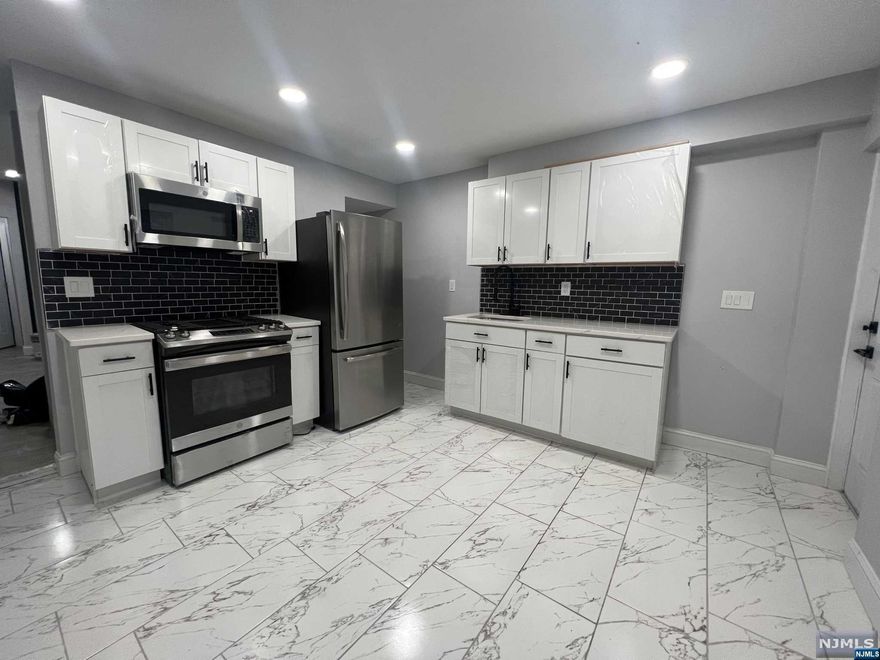 A beautifully renovated single family row home in a desirable section of Kearny! The layout features: 2 bedrooms, 1 full bathroom, living room, eat in kitchen. The house feature recess lighting; brand appliances; new furnace and water heater. The backyard offers an amazing enclosed space, perfect for entertaining. Situated in an excellent location, you'll enjoy easy access to local amenities, houses of worship, schools, shopping centers and transportation. Don't miss the opportunity to make this house your new home sweet home in Kearny! LOW TAXES.