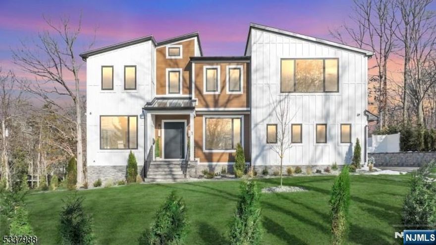 Nestled on a peaceful cul-de-sac in the desirable section of Short Hills, this modern new construction residence seamlessly combines elegance, warmth, and state-of-the-art amenities. The backyard is a private oasis, complete with a stunning gunite smart saltwater pool, covered porch, private balcony & a generous deck surrounded by lush landscaping. 1 Barry exudes refined style with soaring 20ft ceilings, oak hardwood flooring, and custom modern doors. The European custom expansive windows allows natural light to flood the open-concept living spaces. The premier gourmet kitchen features designer light fixtures, 13ft marble island, custom white oak cabinetry, and Thermidor appliances, including double ovens and a massive sized refrigerator. The separate prep kitchen features a Thermador fridge & microwave/oven combo. The home offers 7 spacious bedrooms, each with its own luxurious en-suite bathroom and unique accent walls. The primary suite serves as a personal retreat with a cozy lounge, private balcony & a spa-inspired bathroom. The fully finished entertainment level includes 9ft ceilings, a family room with a fireplace, a second kitchen with a smart fridge, a secondary laundry room, and en-suite accommodations. Outfitted with an advanced security system, Legrand outlets, robust 300-amp electrical system, EV charger & Bluetooth connectivity this home provides unparalleled convenience, security & privacy in one of Short Hills' most coveted locations.