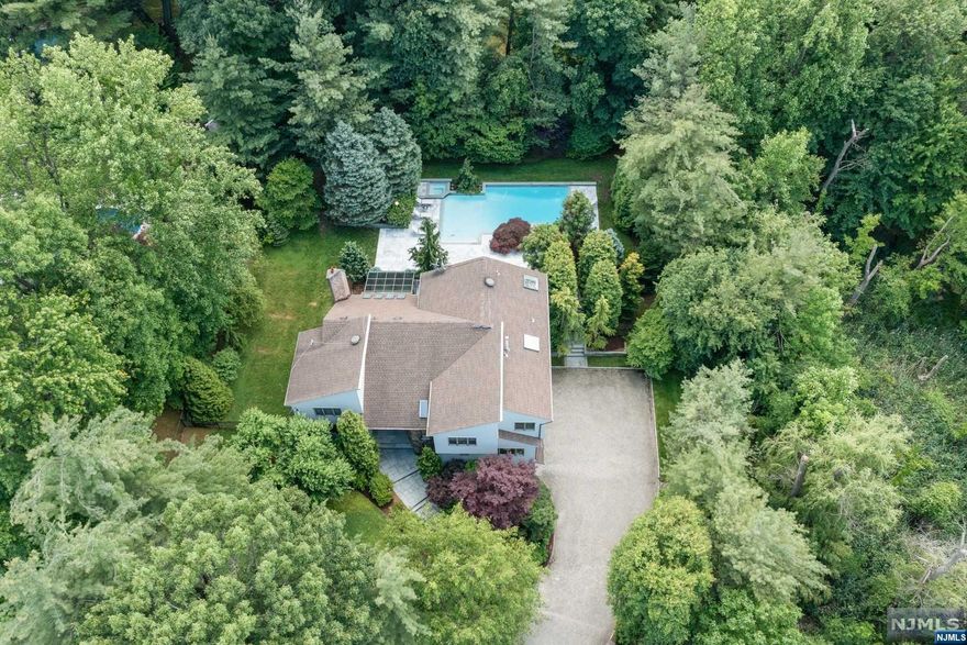 Welcome to an extraordinary contemporary colonial located in the East Hill section of Cresskill. Nestled within private and serene grounds, this home epitomizes luxury living at its finest. As you step inside, be enchanted by the grandeur of high ceilings and bask in the abundant natural light that bathes every room. The meticulously curated high-end marble finishes exude elegance and opulence throughout. With an impressive offering of 6 bedrooms and 4.5 bathrooms, this residence effortlessly accommodates your every need. Indulge in the ultimate outdoor oasis with a gunite saltwater pool and spa, providing the perfect setting for relaxation and entertainment. A lower level guest suite offers privacy and convenience for visiting friends and family. Notably, this residence is situated within the award-winning school system of Cresskill. Embrace the lifestyle you deserve in this remarkable property, where extravagance and sophistication harmoniously blend.