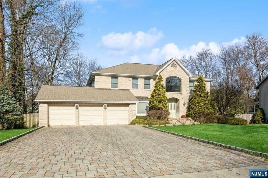 This must-see magnificent home nestled on a sprawling property in one of Closter's most prestigious East Hill cul-de-sacs. Imagine relaxing by a soaring stone fireplace in the grand living room, sunlight streaming through the huge windows and warming the inviting space. Picture yourself entertaining friends in style with the wet bar and spacious layout at your disposal. The chef's dream kitchen awaits your culinary creations. This residence, built by a renowned local builder, boasts high-quality construction with a custom brick facade, charming copper window awnings, and elegant arched windows. The main level features a spectacular great room, perfect for unwinding or entertaining. A spacious eat-in kitchen and a guest bedroom with its own ensuite bath complete this level. This balcony leads to the luxurious primary suite,a second bedroom with an ensuite bath, and bedrooms three and four with an additional bathroom.The full, finished lower level provides endless possibilies