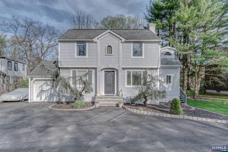 Welcome to this charming colonial boasting 3 BD & 2 full BA situated on a .26 acre flat lot w/ a circular driveway & views of the golf course. Step inside to discover a newly updated eat-in kit, complete w/ ceiling-ht cabinets, quartz countertops & new appliances. Spacious LR w/ its wood-burning fp and seamlessly transition to an open FR / DR with hardwood floors. Walk out from the DR to a spacious newly painted wood deck overlooking the flat backyard. A mudroom & a full BA, complete w/ a steam shower & heated floors, situated near the side entrance for added convenience. Upstairs, 3 generously sized BD w/ hardwood floors await, alongside a shared BA featuring a steam shower. Unfinished basement, perfect for all your storage needs & ready to be finished for additional living space. Also an attached 1-car garage. Garage door will be replaced before closing. Perfectly situated, this home offers easy access to recreation, top-rated schools, shcools, shopping, NYC bus routes