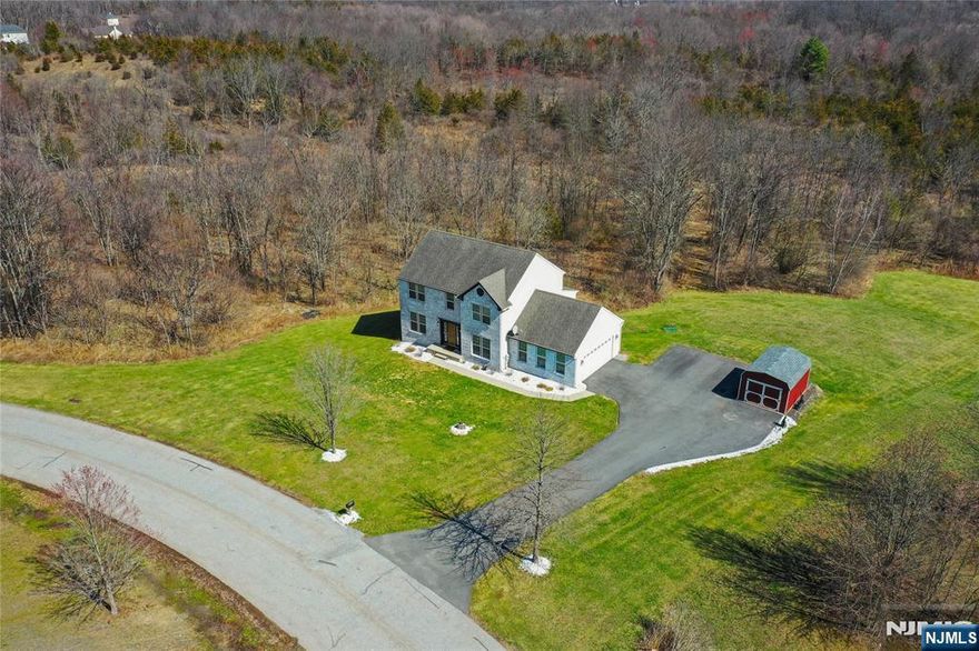 Discover this move-in ready Colonial in the desirable Rolling Hills Estates Subdivision. Surrounded by serene wooded areas on 1.78 Acres, this beautifully updated home offers Kitchen with Granite Countertops, Stainless Steel Appliances, Gas Fireplace, 4 Bedrooms, 3 1/2 Bathrooms, freshly painted interior and a finished walk out Basement featuring a full bath, Recreation Room and Exercise Room, ready for entertaining. New Septic in 2021. Located just minutes from High Point State Park, Mountain Creek Park, Appalachian Trails, and Minerals Spa, this home provides easy access to year-round outdoor activities. Unpack and start enjoying your dream home today!