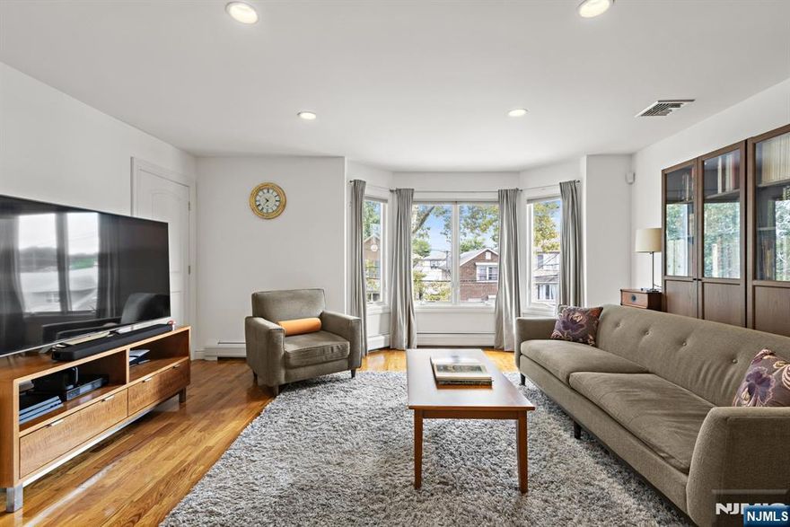 Spacious and thoughtfully designed three-bedroom, two-bathroom condo complete with one-car garage parking. The open-concept living and dining area at the front of the home provides an inviting space for both relaxing and entertaining. The large kitchen features an abundance of warm cabinetry, a stylish tiled backsplash, granite countertops, and stainless steel appliances. The private primary suite boasts generous closet space and a full bath with a Jacuzzi tub. Additional highlights include hardwood floors throughout, a large laundry room with side-by-side washer and dryer, central heating and cooling, and extra storage conveniently located behind the garage. Ideally situated near the Bergen Boulevard bus stop, this home offers an easy commute and a comfortable, convenient lifestyle.