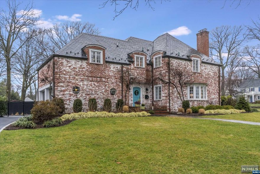 Designed by master architect/builder George Peterson in 1938, this gorgeous French Manor style home boasts an all brick ext, slate roof & custom poured concrete that allowed curved int. walls & larger rooms. Beautifully updated through the years, highlights include: cooks kitchen w/long island & newer appliances, w/addlt. eat-in or rec. space; family room w/wood burning FP; and sun room w/side porch overlooking the expansive grounds. The 2nd floor hosts 4 bright, over-sized Bedrooms, incl. Primary Suite, all w/ample closets; lrg. Hall Bath & walk-in linen closet. The 3rd level has 5th bedroom, full bath & storage. The basement provides an addtl. 725 sq ft of living space that includes: rec/gym areas, a laundry rm, wine closet & tons of storage. Best part is the dream property completely redone in 2023; new salt water pool; built-in kitchen; blue stone patios, leveled yard w/new irrig. & drainage, & night lighting. 2 Blocks from Willard & mins. to train. Visit for more highlights.