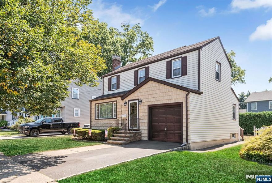 Location, Location, this 3 bedroom, 1.5 bath colonial offers walking distance to bus. Large living room with fireplace that has been relined and ready for a cool winter night. Buyer can remove carpeting to show off hardwood floors on both levels. Solid home that can be a show stopper with a little updating. Partially finished basement adds to space. This home boasts a private level yard, deck, garage and driveway. Central air and gas heat a plus! Windows have been replaced and aluminum siding makes for a maintenance free exterior. If you need to commute to NYC, this is your location!!