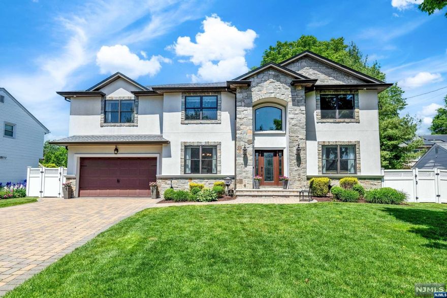 Step inside and experience luxury living at its finest in this exquisite home situated in the highly sought-after West Side of Paramus. This newer build (2014) offers gorgeous finishes inside and out. Beautiful curb appeal with white stucco exterior on all sides. Inside, you'll find 5 spacious bedrooms and 5 full bathrooms, along with a large finished basement and a 2 car garage. The grand two-story foyer leads to a formal living room, dining room, great room, and a recently renovated kitchen (2024) boasting designer cabinetry, professional-grade appliances, and a large center island. Bedroom on the first level makes ideal guest room or home office. All bedrooms are generously sized. Primary Suite offers double WIC's and a large primary bathroom with jacuzzi tub, shower, and double vanity. Amazing outdoor oasis with a heated in-ground pool & an outdoor kitchen. Paramus offers low taxes, amazing school district, and excellent shopping!