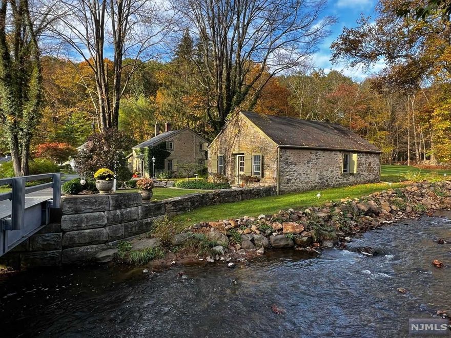 WOW! THIS IS A DREAM GETAWAY YEAR ROUND! ABSOLUTELY CHARMING DETAILS FROM YESTERYEAR, STUNNING HEARTH/ FIREPLACE IN WOOD BEAM CEILING LIVING RM, WIDE HARDWOOD FLOOR PLANKS. HOUSE HAS MANY UPDATES INCL; RENOVATED KIT W/SOAP STONE COUNTERS, STAINLESS STEEL- APPLIANCES, UPDATED BATH. DETACHED GARAGE W/ STUDIO & LOFT! BRICK PATIO OVERLOOKING WOODED SETTING NEXT TO A SPARKLING STREAM, SECONDARY SHED FOR OUTDOOR STORAGE, SITTING AREA/ PATIO BY RIVER. PICTURESQUE VIEWS. GREAT FOR ENTHUSIAST OR SOMEONE LOOKING FOR EXTRA WORK SPACE/WORKSHOP.