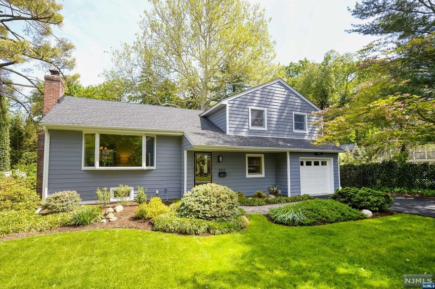 Welcome to this lovely home in the heart of Somerville. A classic sugar maple split level, it features a light and bright living room with high vaulted ceilings and wood burning fireplace. The living room opens into the formal dining room, with french doors into the three-season sunroom. The sunroom offers lots of light and sweeping views of the property's deep lot, with direct access to the patio. The newly updated eat-in-kitchen connects to the front-to-back family room. First floor laundry, a full bathroom and attached garage complete the first floor. Upstairs there are three bedrooms with an updated hall bath. Lots of room for storage in the two large attic spaces, one with pull-down stairs. The home features a finished basement with an office. The deep backyard hosts mature trees for added privacy, and a patio for the perfect oasis. Roof less than one year old, and in-ground sprinkler system. Award winning school system and convenient NYC Train and Bus in Village.