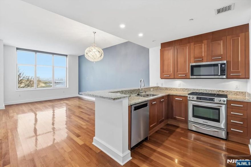 Chic 2-Bed, 2-Bath Condominium at The Watermark â€“ Prime Hudson River Waterfront. Beautiful wood floors add warmth and sophistication to the open living space layout. The modern kitchen boasts wooden cabinetry, sleek stainless steel appliances, and elegant countertops. The spacious living room offers breathtaking northeast-facing views of the Hudson River, filling the space with natural light. The primary suite is a tranquil retreat, featuring a generously sized bedroom, an en-suite bathroom with a soaking tub, and a large walk-in closet. The second bedroom also includes a walk-in closet, enjoys westward exposure, and is conveniently located near the second full bathroom and in-unit washer/dryer. 1 deeded parking spot included. World-class amenities at The Watermark include over 40,000 sq. ft. of indoor and outdoor resort-style facilities, featuring indoor and outdoor pools and hot tubs. Fully equipped fitness center featuring a steam and sauna room.Children's playroom, Pool table, and media room.Golf simulator and business center.Private shuttle to Weehawken Ferry, valet parking, and 24-hour concierge service.Guest suite available on-site for visitors. Enjoy seamless city living with easy access to NYC (via a private shuttle to the ferry) or the NYC bus service just outside your door.Perfect blend of lifestyle and long-term investment value