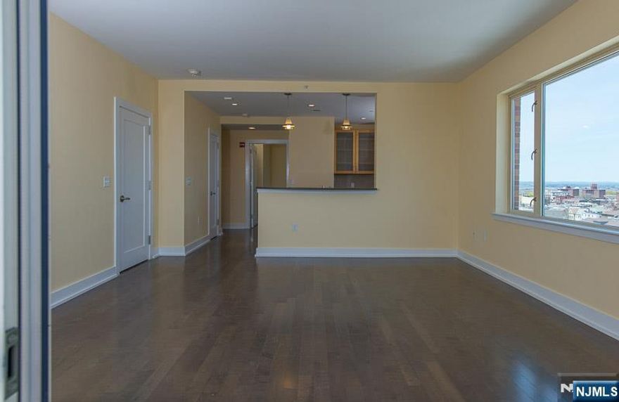 This luxurious 2-bedroom, 2-bathroom condo offers a blend of modern living with spectacular panoramic views of NYC skyline. This bright and airy corner unit is flooded with natural light and creates a serene backdrop for relaxation. Open concept living and dining room is perfect for entertaining. Gourmet modern kitchen is a chef's dream, featuring SS appliances, granite countertops, ample cabinet space and breakfast bar for casual dining. Enjoy your morning coffee or evening cocktails on your private balcony. Primary bedroom includes luxurious en-suite bathroom w/modern fixtures, dual vanities, soaking tub and separate shower and WIC. Spacious 2nd bedroom, perfect for guests, office or nursery. CA, Bosch W & D. 1 Parking space included. Amenities include 24 hr concierge services, residence lounge, fitness center, childrenâ€™s playroom, outdoor BBQ patio and billiard room. This prime location is situated in a vibrant neighborhood, walk to shops, restaurants, parks. Steps form NYC bus makes this location unbeatable.