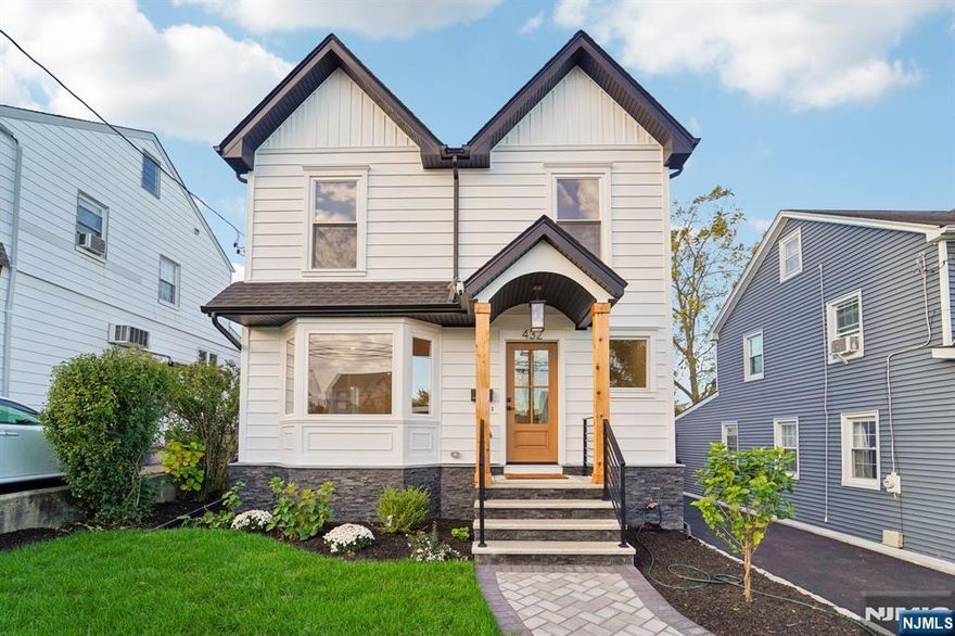 Completely Rebuilt & Expanded in 2025! This stunning 4-bedroom, 3.5-bath colonial offers contemporary curb appeal with all-new modern comfort. Every detail has been rethought to deliver clean design, open flow, and modern sophistication. The open-concept main level features a designer kitchen with a 36" chefs range, 8-foot island, wet bar, and sliding doors to a new composite deck perfect for entertaining or everyday living. Upstairs, the primary suite includes a walk-in closet and spa-inspired bath with double vanity and dual shower. Three additional bedrooms, a full hall bath, and convenient second-floor laundry complete the level. The finished basement adds valuable living space with a wet bar, full bath, and plenty of room for a media area, playroom, or guest suite. Additional highlights: true oak floors throughout, two-New HVAC units, EV charger hook-up, all new plumbing and all new electric, new garage, paver walkway, and fresh landscaping. Move-in ready with designer finishes, flexible spaces, and energy-efficient comfort crafted for todays lifestyle. Prime commuter convenience just steps to the corner bus stop and two NJ Transit train lines in town offering service to New York City. Exceptional walkability! Leave the car at home and stroll to Wood-Ridges charming restaurants, shops, houses of worship, and top-rated schools. Property tax estimate has been received from municipality and current. (Listing agent is owner/seller.)