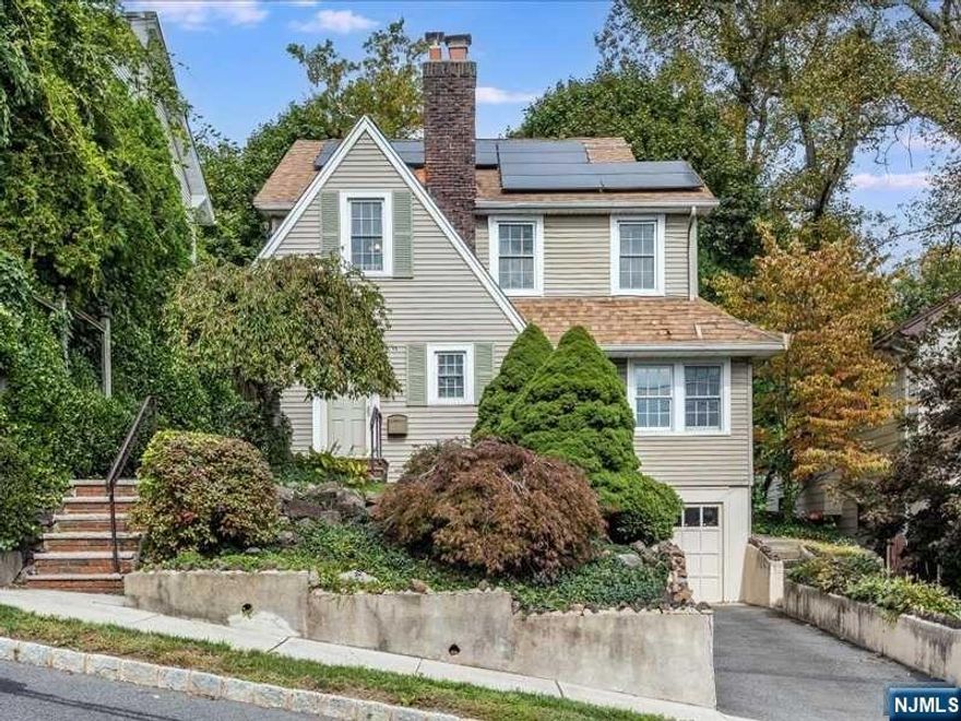 Picture-perfect home in the desirable Gregory section, boasting breathtaking views of the NYC skyline. The first floor showcases original hardwood floors and a cozy wood-burning fireplace as its focal point. Lovely arches define the first floor spaces, which include an eat-in kitchen, dining room, den, powder room, and a dedicated office ideal for working from home. Upstairs, you'll find a full bath and three bedrooms, including a primary bedroom with stunning views. The 3rd level offers a spacious flex area, perfect for a movie room, office, or additional guest space. The basement features a full bath, ample storage, & access to the 1-car garage. Outside, the backyard includes a beautiful patio, perfect for BBQs & a lovely grassy area great for outdoor activities. This home is conveniently located near the South Mountain Recreation Complex, which includes Turtle Back Zoo, The Waterfront, MiniGolf Safari, Regatta Playground, & Park N Ride, offering service to 3 train stations.