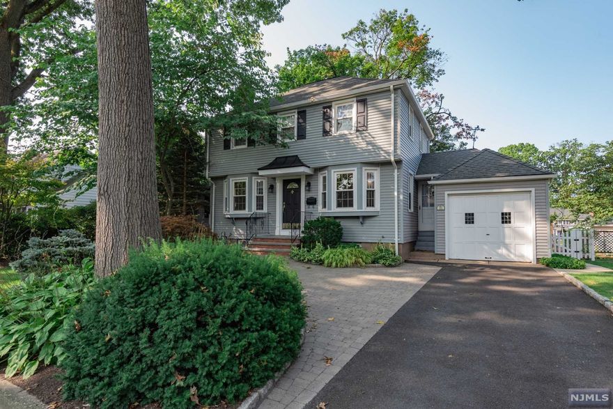 Classic colonial located on a desirable cul-de-sac and just a block from downtown, schools and NYC transit. The first floor of this three bedroom, one and a half bath home offers back to front living room, formal dining room, an eat-in kitchen, powder room and den. On the second level are the primary bedroom, two additional bedrooms and full bath. Features include central air, hardwood floors on both levels, fireplace, built-ins, underground sprinklers and an attached garage. Enjoy outside dining on the lovely patio overlooking fenced yard. All this in town known for highly ranked schools and convenient commute to NYC.