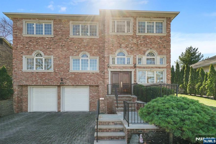 Welcome to 55 Anderson Ave, a stately brick colonial in prestigious Englewood Cliffs. This elegant 5/6 bedroom, 5 full & 2 half bath residence offers over 4,000 sq ft of thoughtfully designed space with rich hardwood floors throughout. A grand foyer with radiant heated floors welcomes you into sunlit rooms and soaring ceilings. The gourmet kitchen features Viking appliances, radiant heated stone floors, a spacious eat in area & sliding glass doors to the backyard. Enjoy the flexibility of a first floor bedroom with office/2nd bedroom, full bath, powder room, and laundry room. Upstairs, find four gracious-sized en suite bedrooms, including a luxurious primary suite with a large walk in closet, and a bonus custom WIC/office. The finished lower level is perfect for entertaining or relaxing with a rec room, bonus room, and half bath, plus direct access to the oversized 2 car garage. Freshly painted and move in ready with an enclosed backyard, this home is a true standout.