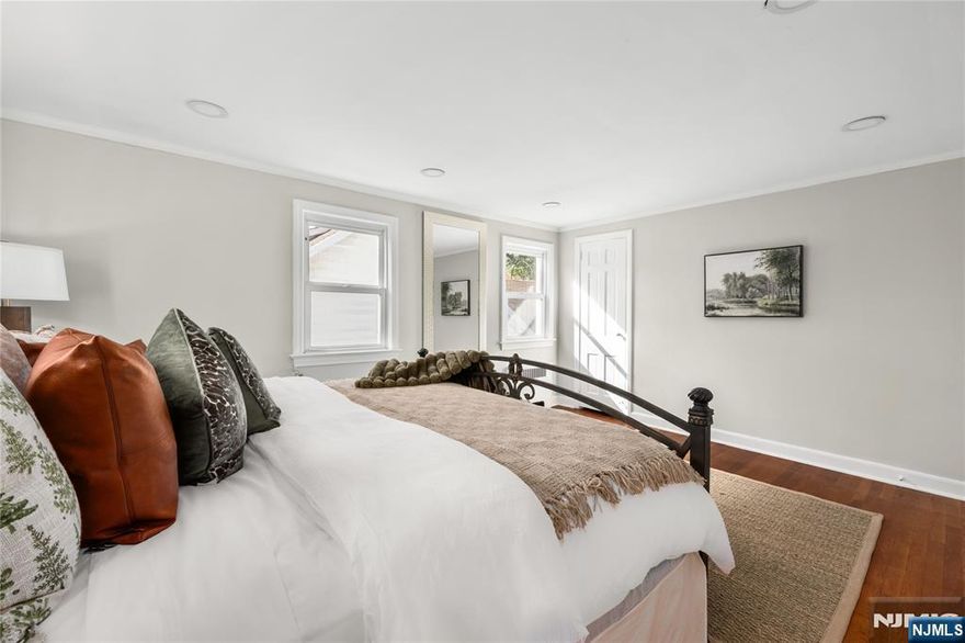 Step inside this beautifully renovated three-bedroom, two-and-a-half-bath Colonial in the heart of Maplewood, New Jersey. A home that blends modern comfort with timeless character. Take in the kitchen's heated floors and sleek, 11-foot center island that flows into the dining area. A spacious living room with wood burning fireplace and original hardwood floors invite you to a multipurpose sun studio and opens to an expansive modern deck. Wrought iron railings lead you upstairs where you'll find three inviting bedrooms, a full bath with relaxing jacuzzi tub and separate shower, along with convenient access to a walk-up attic for added space. The finished basement is complete with original terrazzo floors, dual entrance, full bath and provides ultimate versatility, whether for guests, a home office, or recreation. Multiple parking spaces precede a two-car garage, greeted by a quaint backyard gazebo. Ideally located just minutes from the South Orange and Maplewood train stations, with quick access to schools and universities, local jitneys, major highways, parks, airports, and the vibrant downtown.