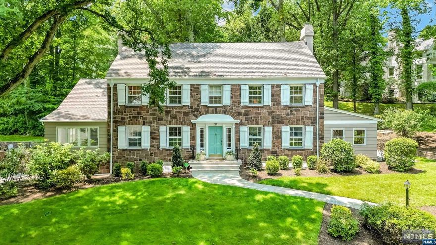 This sun-soaked and charming stone-front Center Hall Colonial boasts a prime corner location on the most picturesque and desirable streets in South Orange. Perched on an elevated lot with mature landscaping and an enclosed sunroom, the property features 4 oversized bedrooms, including a stunning primary suite with an updated all-marble spa bathroom and a custom-built his/hers WIC. With original oak hardwood floors, a wood-burning fireplace, and decorative moldings throughout, this home blends original character and quality with contemporary conveniences like a modernized kitchen with high-end appliances, updated bathrooms, central air, and a heated 3-car garage. Offering a private backyard with a bluestone patio, a stately formal dining room, and a fully finished basement, there are plenty of exceptional spaces to choose from when entertaining. Just less than a mile from the shops and restaurants of downtown South Orange, this property is a commuter's dream.