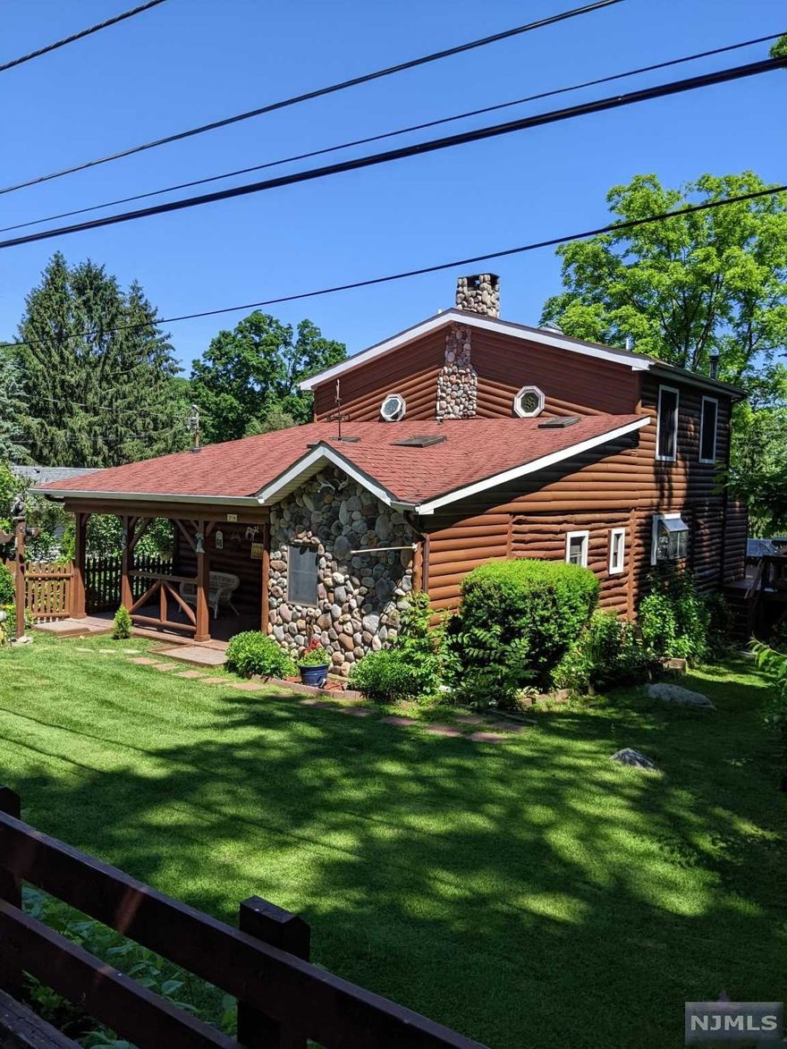 Totally one-of-a-kind Log home w/character galore!So many nooks & crannies, so much to see.Front sitting porch w/pavers.Tiled entry foyer w/cedar lined closet. LR w2 skylights,cath clg,exposed beams,hdwd floor,stone FP w/glass enclosure storage closet.TV shelf,TV,stereo, & hutch all stay.Oversized eat-in kitchen w/ceramic tile floor,breakfast bar area w/corian peninsula, granite tops & undermount SS sink,SS D/W & stove (gas).Refrigerator,built in microwave & wall hung TV stay.Full ceramic tile bath & vanity w/corian top.Parquet floor den w/closets & stained glass leads to oversized FMR w/skylight,vaulted clg, hdwd floor,built-in shelving & wood stove.Sliders to huge entertainment sized deck w/built-in hot tub.Second floor has three BRs (2 bedroom septic).One bedroom has octagon window,another has walk-in closet.All have solid pine doors.Master BR w/vaulted clg w/skylight & walk-in closet. All bedrooms & den have recessed lighting. Upstairs full bath has vaulted ceiling & skylite.