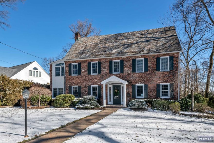 Impressive classic Colonial home in the sought out Old Country Club Area of Ridgewood enhanced with a slate roof, and many updated amenities throughout. The large kitchen with updated appliances features an eating area, and opens to a fabulous family room with fireplace and picture window overlooking the backyard & pool. This level also features a formal LV w/ fireplace, updated PR, and den/office. The 2nd floor features an impressive primary bedroom suite with large bathroom, walk-in closet and double outfitted closet. Two more bedrooms and one bath complete the second level. The third level features an additional two bedrooms and one bath. Finished basement with porcelain tiles hosts rec room, fitness area & PR. Lush landscaping complements the lovely, fully-gated pool. A large deck off the family room offers more outdoor enjoyment. Convenient to schools, town, & NYC transportation. Updates include: basement, heating, 3 bathrooms, & appliances. Will Not Last! Must See!