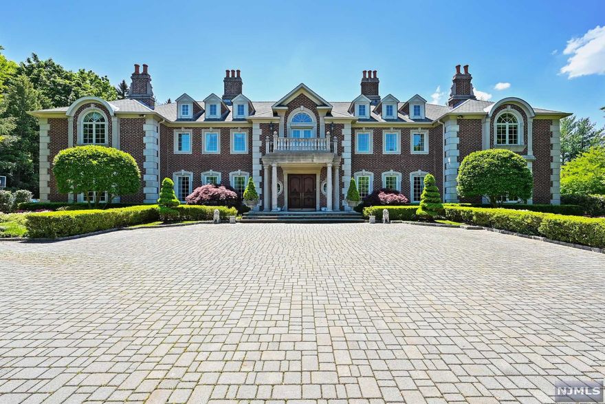 A long, majestic tree-lined driveway approach leads to a classically symmetrical red brick colonial, flawlessly executed to accomplish a cohesive flow for grand scale entertaining. Timeless in beauty and indistinguishable from new; the main level features a palatial front to rear foyer with two circular staircases. Additionally there are five large receptions room with high ceilings, many with egress to a south facing, private, flat great lawn spanning shy of two acres. Throughout the home, there are six bedroom suites, including a sumptuous three-room master chamber. The lower level is full and finished. The property can accommodate both a pool and tennis court.