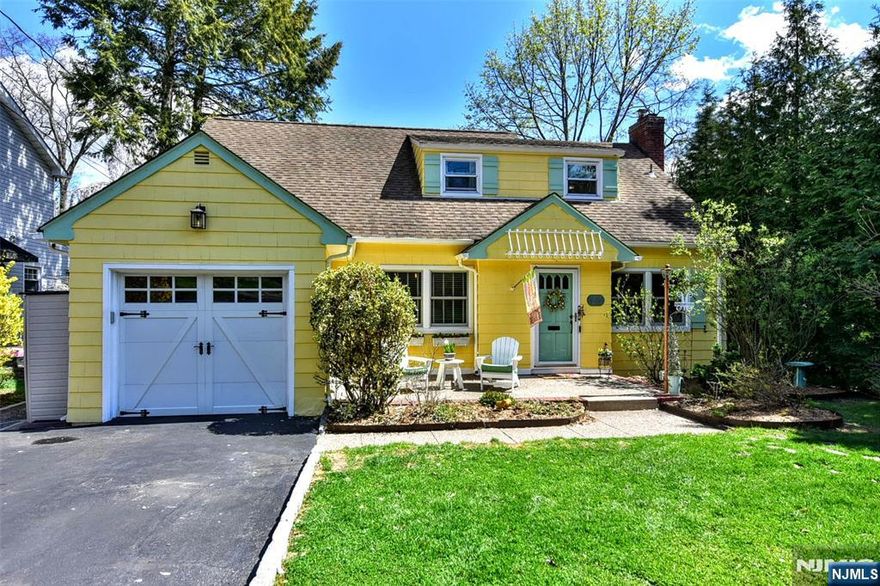 Charming Colonial in a Prime Ridgewood Location! This beautifully maintained 4 BR, 1.5 bath home offers warmth, character & flexible living space close to parks, schools, commuter options & vibrant downtown Ridgewood. Features: Hardwood floors throughout, newer windows & a freshly painted interior. The front-to-back living room w/ a wood-burning fireplace & abundant natural light creates a warm inviting space. A formal, spacious dining room is ideal for entertaining. The updated eat-in kitchen w/ stainless steel appliances opens to a screened-in 3-season porch. Step outside to a fully fenced yard landscaped for privacy. The deep lot has multiple areas for relaxing & hosting gatherings. The bright & sunny 4th BR on the 1st floor is currently a thoughtfully designed flex space. Upstairs, 3 spacious BRs include a primary suite sized for a king bed, 2 closets & a tranquil sitting nook. The bathrooms are bright & updated. The lower level expands your living experience, perfect for media, wellness or hobbies. Highlights include an attached garage styled as a mudroom w/ attic storage & a generous driveway w/ parking for 4 cars. The yard is landscaped offering privacy w/ beautiful views from the many windows in this home. Ridgewood offers an exceptional lifestyle w/ top-tier schools, NYC bus/train, recreation opportunities, downtown with restaurants & boutiques, all complemented w/ a strong sense of a small- town community. A must see! You're going to LOVE living in Ridgewood!