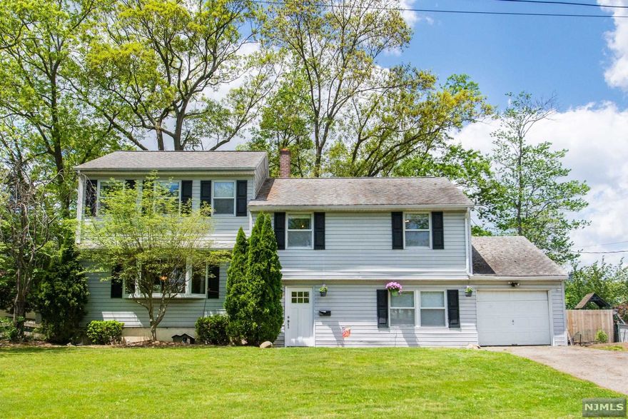 LOCATION, LOCATION, LOCATION! 4 Bedroom 2.5 bathroom Split Level in Prestigious LIVINGSTON on .27 acre LEVEL LOT! Main Level hosts a Bright Living room with Bay Window and OPEN flow to Dining Room and Kitchen w/SLIDER to Deck overlooking FENCED-IN backyard. Ground Level Family Room w/Powder Room, Laundry and WALK OUT to PLAYABLE backyard. 2nd Level Hosts 3 Bedrooms and a Full bathroom. A few Steps up is MASTER En-Suite ADDITION with Private office and Walk in Closet. GREAT layout & potential for Expansion & to make this home your own! Short Stroll to top rated Livingston HighSchool, Hillside Elementary, NYC Bus, Library and more...everything important that Livingston has to offer!