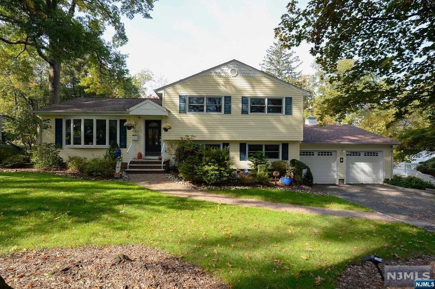 Lovely home located on a beautiful tree-lined street in desirable Packanack Woods, This home offers 3 bedrooms,2 1/2 baths.Newer Kitchen in 2019, with custom cabinetry,granite counters.stainless steel appliances.Living Room with Bay window,hardwood floors underneath newer carpeting.The 2nd floor offers primary bedroom with updated en suite with radiant flooring.2 additional bedroomswith an updated full bath.Ground level offers a spacious family room with a dry bar with custom cabinets, beverage cooler and wine refrigerator for entertaining.Mudroom/laundry room with custom cabinetry,granite countertop with newer Samsung appliances,Updated half bath and acces to a 2-car garage. Ground level also provides access leading to a beautiful professionally landscaped backyard.Paved patio with outdoor furniture and weber grill included. Additional features include:Underground Irrigation system.Invisible fence,Hardwood flooring, Washer & Dryer,Excellent School System,Lake dues are optional