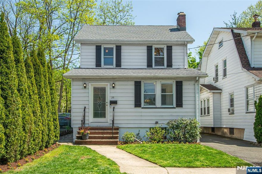Welcome to this picture-perfect Colonial, perfectly situated at the end of a quiet residential street offering privacy and charm. Cute as a button, this home blends timeless character with modern updates, featuring original wood floors, classic doors, and detailed moldings throughout.The bright and inviting interior has been recently painted, creating a fresh and elegant atmosphere. Find a convenient, spacious front porch before entering the formal living room, private sun room and formal dining room. Enjoy cozy evenings by the wood-burning fireplace, adding warmth and character to the open and airy living space.The kitchen is equipped with stainless steel appliances, ideal for both everyday living and entertaining. Upstairs you find three well sized bedrooms and a full bath. A walk-up attic provides abundant storage and offers excellent potential to be converted into an additional bedroom, home office, or flex space perfect for today's lifestyle needs. Finished lower level serves as a practical rec room and laundry room, adding more to the living space. Step outside to enjoy the lovely fenced-in backyard, beautifully landscaped and private. The bucolic patio and pergola will gift you endless relaxation. Oversized 1 car garage and exclusive driveway. Commuters will love the convenience of a nearby shuttle to the Midtown Direct train, making travel to New York City seamless. Located close to shopping, dining, parks, and top local amenities. Don't miss it, this one is perfect!