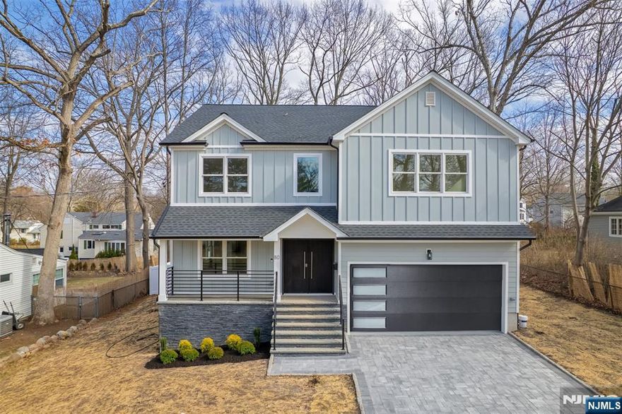 Discover this exquisite new colonial home in one of Livingstonâ€™s most sought-after neighborhoods. The covered entry porch leads to a grand double-height foyer, filling the space with natural light. The main level boasts an open layout with a formal living room, elegant dining room, guest ensuite, and stylish powder room. The gourmet eat-in kitchen features custom cabinetry, a spacious island, and high-end appliances. The sunlit family room has a fireplace and sliding doors to a deck and patio, perfect for entertaining. Upstairs, find four bright bedrooms, including a luxurious primary suite with dual walk-in closets, a spa-like bath, and a private balcony. The finished basement offers large open spaces, an office, a recreation room, and a full bath. Modern features include EV wiring and a garage battery backup. Conveniently located near shopping, top-rated schools, parks, and NYC transit, this smart home offers elegance and convenience