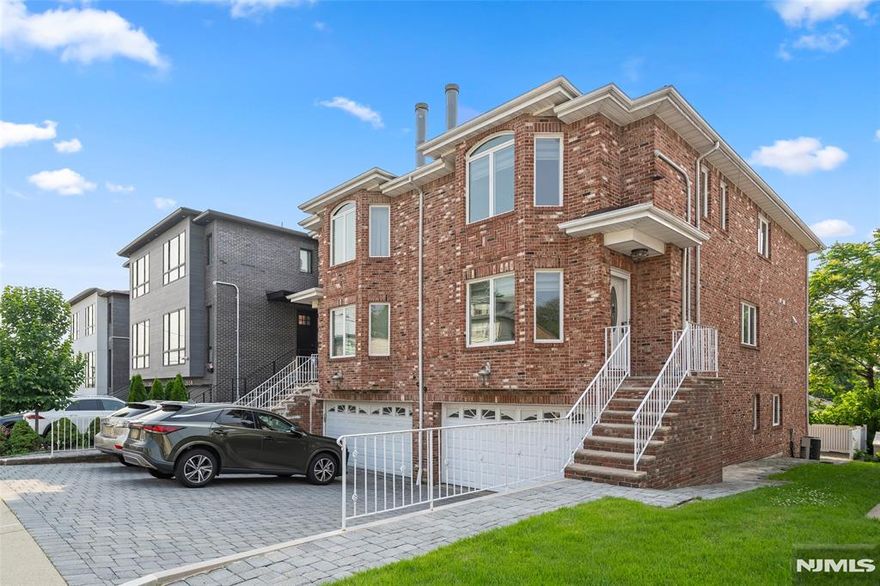 Welcome to this beautifully maintained and oversized duplex, ideally situated just one block from vibrant Broad Avenue. Featuring hardwood floors throughout, this home exudes warmth and character from the moment you step inside. The main level offers a spacious and inviting layout, including a bright living room with a cozy fireplace, a formal dining area perfect for gatherings, and a large eat-in kitchen complete with granite countertops and stainless steel appliances and a thoughtfully placed laundry. A convenient powder room and sliding glass doors leading to a private deck make entertaining a breeze. Upstairs, youâ€™ll find a generous primary suite with a walk-in closet, along with two additional well-sized bedrooms, a full bathroom. The fully finished basement expands your living space even further, featuring a massive recreation room, a full bath, and direct access to the backyardâ€”ideal for guests, a home office, or entertaining. Located in a prime spot with low taxes, this home offers easy access to NYC-bound buses, local dining, shopping, and everything else this vibrant area has to offer.