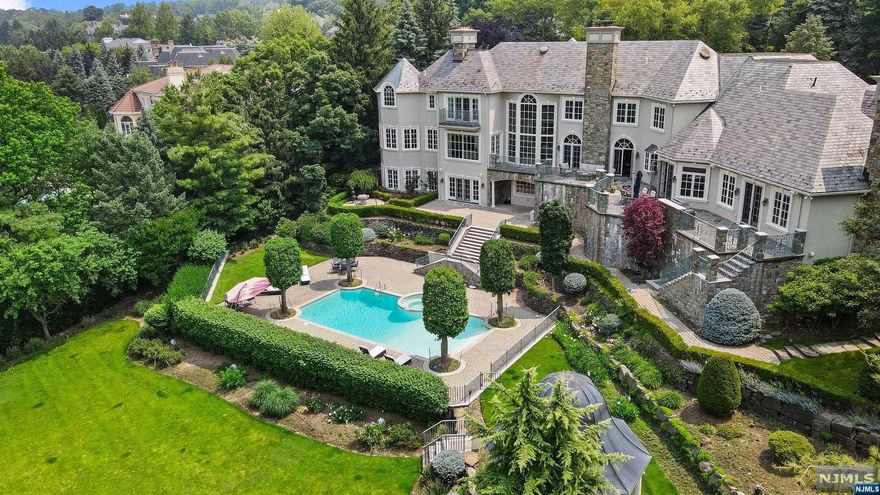 SPECTACULAR most MAGNIFICENT French Chateau EAST EXPOSURE on prime 1.58 acre RIO VISTA Cresskill w/stunning mountain views. This one of a kind residence is designed by well known architect James Nigro. A GRAND 2 Story Entrance that leads to the 2 Story Sun-Drenched Solarium overlooking the Resort-Like rear yard with GORGEOUS POOL & GAZEBO. Cherry Office/Study w/Fpl, Formal Living Rm w/Fpl, Dining Rm w/Fpl, Kitchen w/walk in Pantry, 2 new Sub-Zero Refrigerators, Thermador 6 Burner Range, MAJESTIC GREAT ROOM w/Stone Fireplace, 2 Story Hand Painted Ceiling & built in Wet Bar w/Copper Bar countertop, Bedroom, Full Bath & 2 Powder Rooms. Second level has an Impressive Primary Suite w/High Ceiling & Balcony overlooking rear yard, 4 bedrooms, 2 Jack & Jill Baths, Laundry #1. Full Walkout basement w/Kitchen #2, Bar, Sauna, Full Gym, Full Bath, Rec/Game Rm, Nanny area, Full Bath, Future Theater Rm. 3 car Garage w/electric vehicle charging hub, SLATE ROOF & Poured Concrete Foundatio