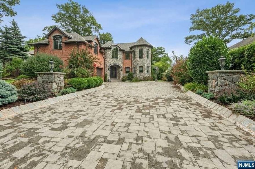 Spectacular Custom Built Brick Colonial with Nantucket Blue Stone 5 years young is waiting for you! Approx, 4496 square feet not including Basement Level with approx. an additional 2000 sq. ft. Impressive foyer with open circular staircases overlook beautiful great room. Luxury throughout including designer Peter Salerno kitchen and baths. Great open floor plan for entertaining! Primary suite has three oversized walk in closets with breathtaking master bath. Oversized attic storage. Basement level light and bright with 9' ceilings and 2nd separate back entrance with built in wall of custom cabinetry/bar in family room, gas fireplace, gym, media room with custom built ins, office (w egress windows) and full bath. Lots of storage. Radiant heat under all tile, baths and basement. Perfect for extended family. Just minutes to Manhattan!! A definite must see!! Owner is a licensed NJRealtor.