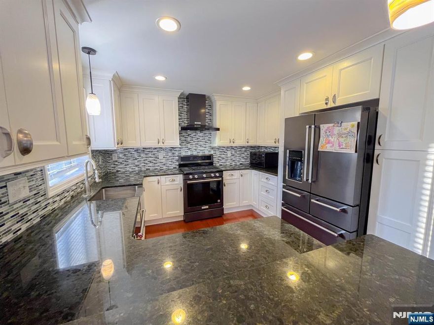 Welcome to this beautifully maintained 4-bedroom Colonial located on a quiet tree-lined street in Totowa. This home features a spacious layout with a sun-filled living room, formal dining area, and an updated kitchen with granite countertops, KitchenAid appliances, and a separate eating area. The second floor offers four generously sized bedrooms, while the fully finished walk-out basement includes a family room, office/den, laundry area, and additional space for flexible use. Enjoy your own private backyard with an above-ground pool, deck, and hot tubâ€”perfect for relaxing or entertaining. Conveniently located near major highways, shopping, and restaurants.