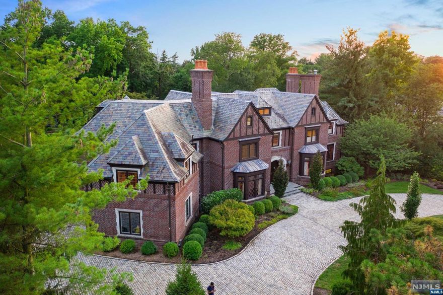 Welcome to Hamptons style living on the East hill of Englewood,just 4 miles to NYC is this magnificent country estate, including pool,pool house, tennis court and Koi Pond occupying four levels of sumptuous detail.An atmosphere filled with warmth and sophistication created by renowned designers and award winning construction.Magnificent fireplaces,eclectic library staircase and furnishings sourced from English Manors,P.E.Guerin hardware,blend with refreshing modern appointments and state-of-the-art amenities. Approximately 15,500 sqf, comprised of 8 Bedrooms of which 6 are ensuite,9 full and 4 half Baths,5 Fireplaces, professional Chef's Kitchen,Great Room.Plenty of room to play in the lower level which includes a basketball court ,Theatre, Gym, and ESPN Zone with Bar and Billiards. A special highlight is the amazing indoor spa with 8 person jacuzzi, sauna and steam room.Close to houses of worship.A unique opportunity to enjoy country living with NYC at your doorstep.