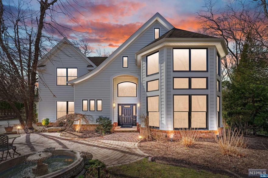 Step into this exquisite CUSTOM center hall colonial, blending classic elegance with modern luxury. Boasting 7,000+/- SF, 5 BEDS / 4.2 BATHS across three finished levels, this home rests on a tranquil cul-de-sac near top-rated schools & NYC transportation. A stunning two-story foyer welcomes you to an open-concept layout. The renovated gourmet kitchen features high-end appliances, a dry bar, and a butler's pantry, extending to a backyard patio with an outdoor kitchen and firepit. A double-sided fireplace connects the living and family rooms, creating a cozy atmosphere. A 2016 rear addition adds a mudroom, laundry, garage access, and a game room with vaulted ceiling and wet bar. Upstairs, the primary suite offers a spa-like bath and expansive closet, with three additional bedrooms and 2 full baths. The finished lower level includes a guest suite, office, gym, wine cellar, media room, and storage. This home promises unmatched convenience and luxury living.