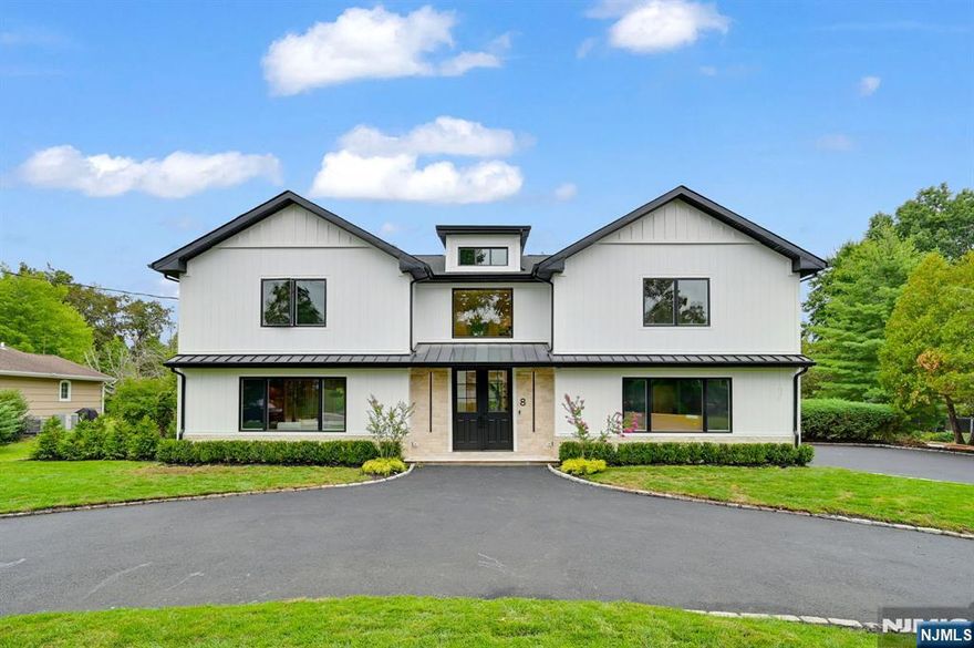 A Stunning Modern Oasis on a Rare 0.59-Acre Flat Lot with a Circular Driveway !!! Welcome home to this fully renovated 5-bedroom, 4.5-bath, 3,736 sq. ft. home that perfectly blends modern luxury with serene, expansive living. Step into a dramatic 2-story foyer that sets the tone for the open, light-filled layout. At its heart is a gourmet chef's kitchen, a true showpiece with Wolf & Thermador appliances, sleek design, and premium finishes. The main level features high-end engineered floors throughout, a formal dining room, elegant living room with electric fireplace, spacious family room, mudroom, and powder room. Upstairs, the luxurious primary suite offers two walk-in closets and a spa-like bath with dual vanities, soaking tub, and stall shower. A junior ensuite, two additional bedrooms with a shared hall bath, and a convenient laundry room complete this level. The finished basement is an entertainer's dream, boasting a spacious rec room, custom wet bar with beverage cooler, a bedroom, and a full bath. Exterior highlights include premium Hardie Artisan siding, an EV-ready 2-car garage, beautifully landscaped backyard, and a large deck ideal for entertaining. Modern comforts include 2 HVAC systems with 3-zone control and a full Ring security system. Set in a top-rated school district with proximity to direct trains to NYC, major highways, & premier shopping, this rare property offers sophistication, space, & an exceptional lifestyle opportunity in Livingston- A Must See !!