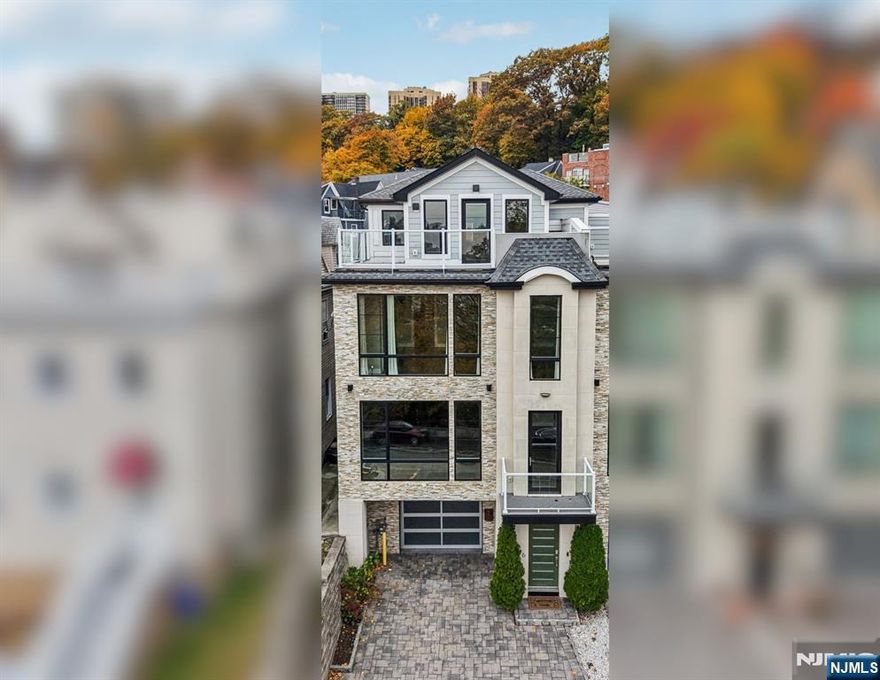 This exceptional 4-bedroom, 4.5-bath luxury townhome offers modern elegance with breathtaking views of the Hudson River and Manhattan skyline. This four-level with PRIVATE ELEVATOR residence features an open-concept main floor with floor-to-ceiling windows, a sleek gas fireplace, custom porcelain accents, and a chefâ€™s kitchen outfitted with Omega cabinetry, granite countertops, Sub-Zero and Bosch appliances, and a massive 14-foot island. Multiple balconies, a private backyard, and a rooftop terrace create seamless indoor-outdoor living. The upper levels include spacious bedrooms, a convenient laundry room, and a Primary Suite with a lounge area, spa-style bath, oversized walk-in closet, and terrace overlooking NYC. Additional highlights include: hardwood floors throughout, a finished basement ideal for a media room or gym, and an attached garage. Perfectly located minutes from the NY Waterway ferry, major highways, shops, dining, and waterfront parks, this move-in-ready home delivers the ideal combination of sophistication, comfort, and convenienceâ€”an Edgewater gem that redefines luxury living.