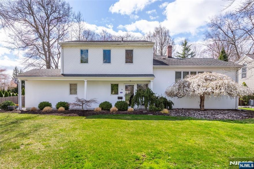 Prime and desirable location, inviting and beautiful property. Features include: beautiful entry foyer open to elegant formal living and dining rooms with cathedral ceilings and impressive window with lots of natural light. Updated kitchen with high end cabinets, granite counters, custom back splash, built in island with seating and sun filled breakfast area open to family room with large slider overlooking the incredible patio and yard. Second floor includes: primary suite with wall of closets and full updated bathroom. Additional 3 bedrooms with newer stylish bathroom. Finished basement with laundry room and recreational room. Enjoy the outdoors: stunning yard and paver patio and multiple sitting areas. Additional attributes: 1 car garage, hardwood floors, recessed lighting, powder room, and updated newer windows. Great Location. Top rated school system. Minutes to shopping, restaurants, major highways, Trader Joes, Whole Foods, library and NJ Transit Bus and Train Center.