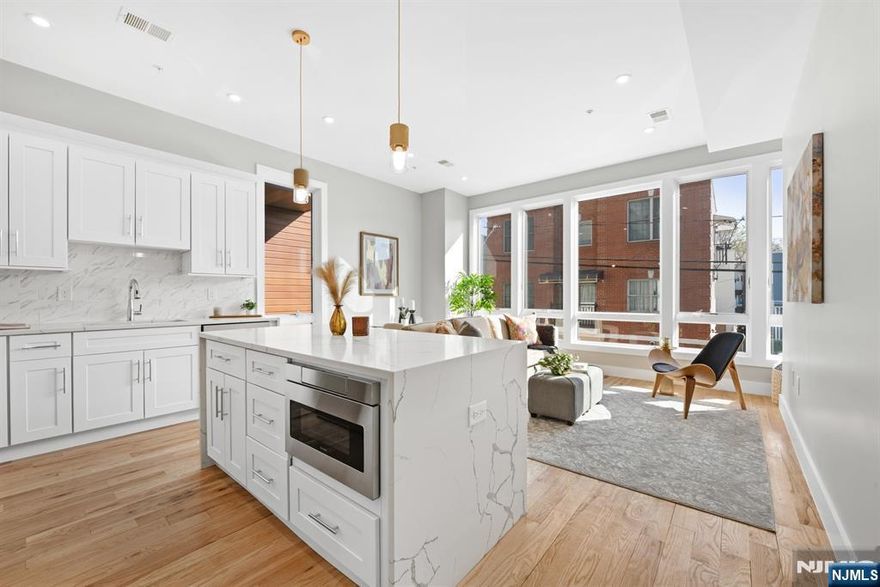 Welcome to 126 Dekalb Ave, a beautifully crafted new construction offering the perfect blend of modern design and everyday comfort. Set on a quiet, tree-lined street just moments from the Journal Square PATH, this property delivers both luxury and convenience. Spanning roughly 1,150 sq ft per floor, this expansive 3-family home includes two spacious 3-bedroom, 2-bath unitsâ€”one with a private rooftop and the other with a balconyâ€”plus a well-designed 2-bedroom, 2-bath ground-floor unit with direct access to a private backyard. Each residence features an open-concept layout filled with natural light, hardwood floors, oversized windows, and refined modern finishes. Designer kitchens showcase premium cabinetry, sleek stone countertops, and high-end fixtures, flowing seamlessly into generous living and dining areas. Spa-like bathrooms offer elegant tilework and sophisticated details. Located in the heart of Journal Square, youâ€™ll enjoy easy access to dining, shopping, parks, and culture, with quick PATH service to Manhattan. A rare opportunity to own a luxury multi-family with private outdoor spaces in one of Jersey Cityâ€™s fastest-growing neighborhoods.