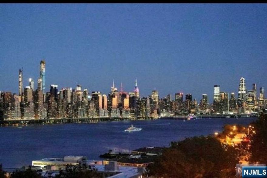 Stunning panoramic view of NYC and Hudson River from this beautiful one bedroom one bath Apartment on the 10th floor of a luxury high-rise building. Large living room and dining area with new hardwood floors, door leading to extra large terrace with incredible NYC view. Oversize bedroom with generous closet space and a modern tiled bath. Outdoor pool, gym, 24 hour concierge, and one garage parking space. Adjacent to 167 acre park with lake. SUPER CONVENIENT COMMUTE TO NYC, HOBOKEN AND JERSEY CITY WITH TRANSPORTATION AT YOUR DOORSTEP!