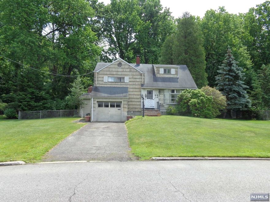 Location, Location, Location! 3 Bdrm expanded split, 1.5 Ba, 1 car built in garage. Hardwood Floors. Large ground level family room with wood burning fireplace, great for entertaining. Level lot with spacious partially fenced rear yard. Conveniently located near transportation, shopping, schools and more! Needs some TLC to be your dream home! Won't last long! Being sold as-is.