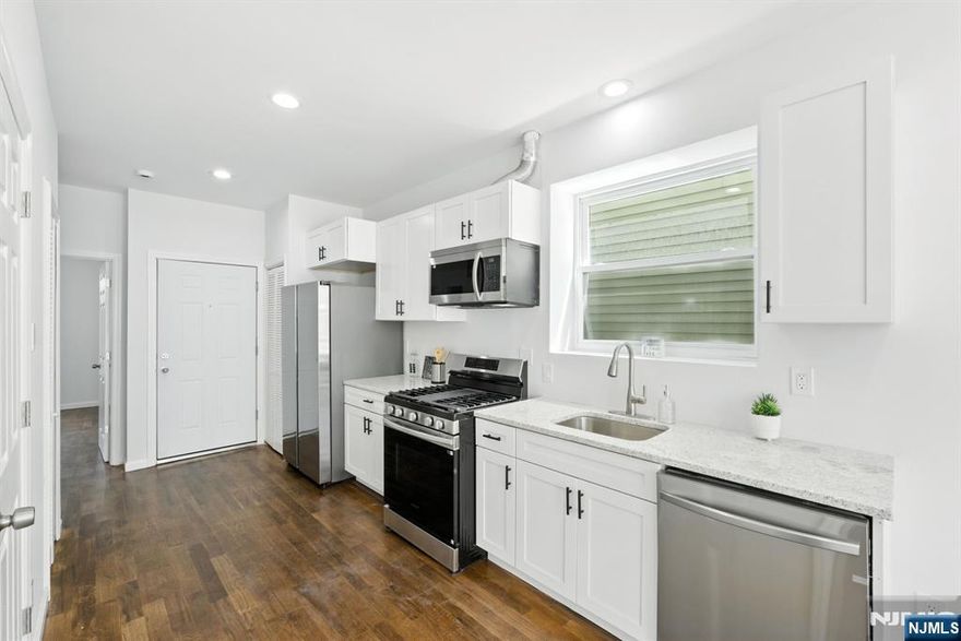 Welcome to the heart of Newark's highly sought-after Ironbound section! This beautifully fully renovated 3-family home (2025) offers modern living with convenience at your doorstep just moments from premier dining, shopping, transportation, and downtown Newark. Each unit features 2 spacious bedrooms and 2 full bathrooms, thoughtfully designed with gleaming hardwood floors, central air and forced hot air, recessed lighting, and tankless hot water heaters for maximum comfort and efficiency. The brand-new chef-inspired kitchens boast quartz countertops, sleek new cabinets, and stainless steel appliances, creating a stylish space to cook and entertain. Bathrooms have been fully remodeled with granite floors, elegant porcelain tiling, and contemporary finishes, offering a spa-like retreat in every unit. Relax and take in breathtaking NYC skyline views from the rooftop, perfect for unwinding or entertaining guests. With its prime location, modern updates, and rare multi-family layout, this property is an exceptional investment or owner-occupant opportunity in one of Newark's most vibrant neighborhoods. Don't miss this one - schedule your private tour today!