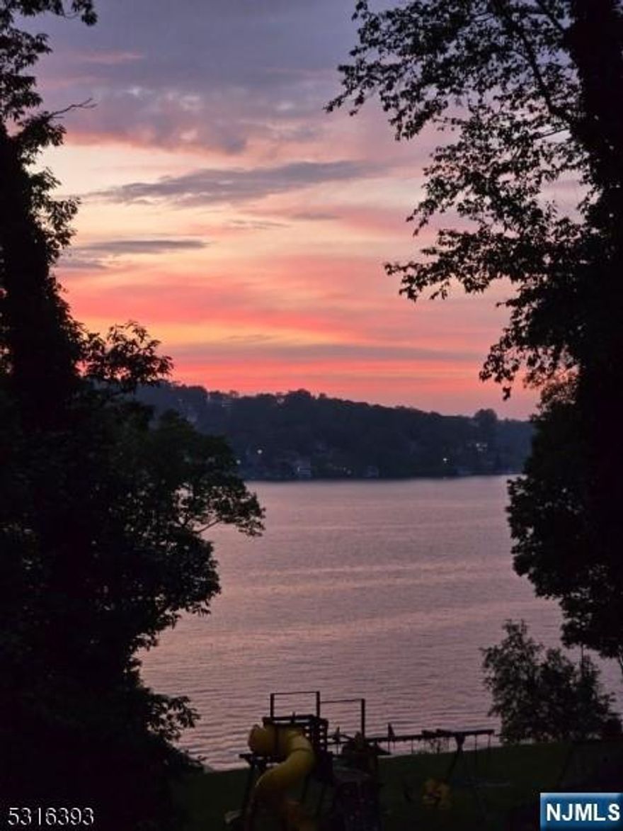 Lake Hopatcong.Main lake property offering unparalleled views privacy, set on over 1.5 acres. Sweeping estate features 195 ft of frontage (as per public record) 208 per survey, providing the perfect backdrop for your dreams be it a multi-generational compound, a private retreat, or an entertainer's paradise. Expansive property, the lower yard is perfect for a pool, tennis court, or any outdoor activity you desire. With an expansive level lawn for sports, a playground, a dog kennel, and various gardens, there's room for everyone to enjoy.Restoration Potential: The existing boathouse foundation is in place, waiting for your vision. Multiple Patios & Walkways: Enjoy beautiful outdoor living with two additional patios, stone walls surrounding the property, and inviting walkways by the garage, perfect for gatherings or peaceful evenings watching stunning sunsets. This home boasts 5 bedrooms, 3 full baths, with numerous updates including new siding roof paint flooring hardware & systems