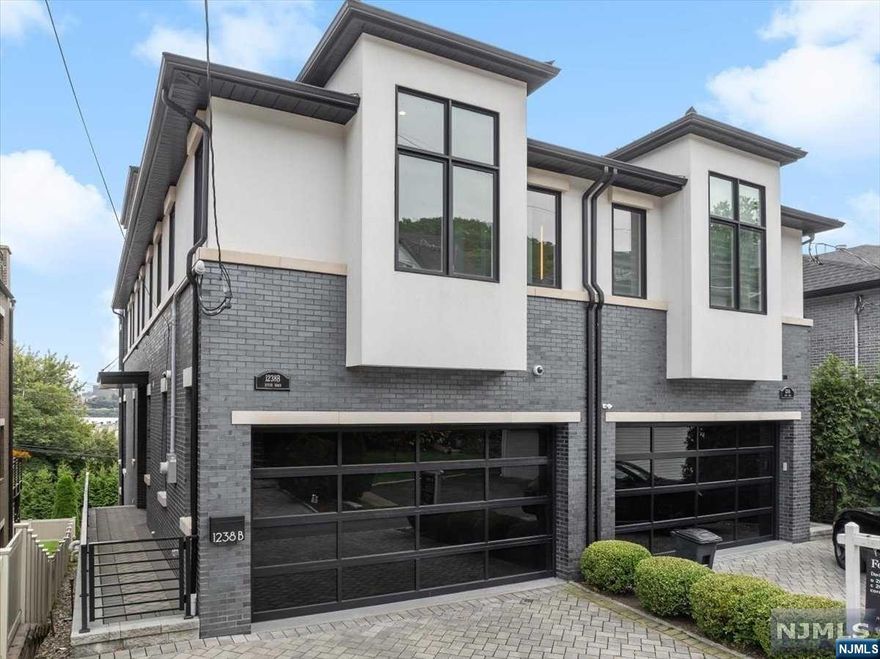 Custom Built oversized townhome by Rock Solid Builders. Spanning four levels, this home features 4 bedrooms all with private ensuites. The living room has 10-foot ceilings, Custom Stone Fireplace and floor to Ceiling windows overlooking the Hudson River with custom electronic blinds. Gourmet kitchen with professional-grade appliances, and Custom Cabinets. 2nd Floor features primary suite, with fireplace, spa like bathroom and custom built-in closet. Top floor, has family room and half bath with doors leading to roof deck with Nyc and Hudson River Views. The ground level has vaulted ceilings, 4th bedroom, full bath, and direct backyard access, seamlessly blending indoor and outdoor living. Smart home is equipped with modern amenities such as a Crestron system, automated blinds, two-car garage with electric charging station, elevator.