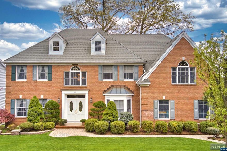 Beautifully maintained center hall colonial nestled in a picturesque cul-de-sac. This inviting home welcomes you with 2-story entry foyer, formal living and dining, and great room with double-height ceiling and stone fireplace. Renovated kitchen with new appliances includes breakfast nook and sliding glass doors to deck, backyard and garden. Office/bedroom, powder bath, laundry and access to 2-car garage complete the first floor. Second floor includes a spacious master suite with jacuzzi and shower, three bedrooms and full bath. Enormous finished basement with wet bar, full bath, bonus room with French glass doors and plenty of space for entertaining, storage and more. One of the best locations in town--with top-ranked elementary school within walking distance, express bus stop to NYC just outside cul-de-sac entry, highway proximity, and easy access to great town amenities.