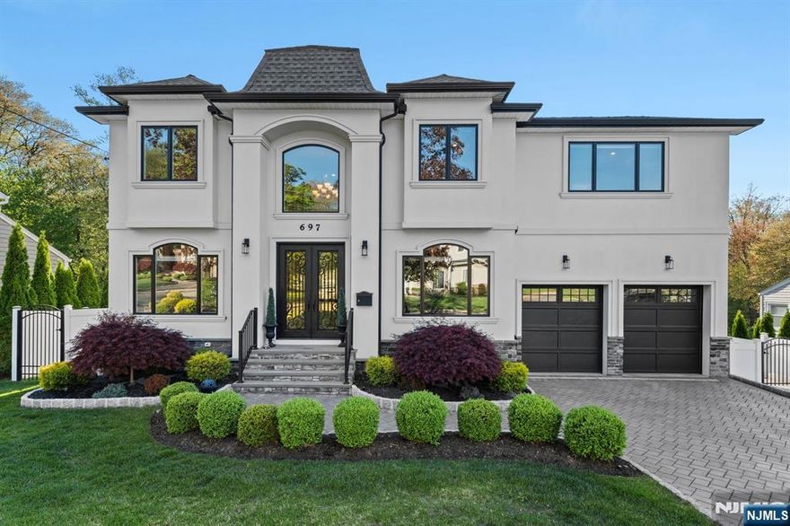 Welcome to this stunning 5-bedroom, 4.5-bath colonial-style home offering 4,043 sq ft of luxurious living space. Built in 2017, the home features a grand double-door entry, elegant moldings, hardwood floors, and an 18-ft coffered ceiling in the great room with a marble fireplace. The chefâ€™s kitchen is equipped with Jenn-Air appliances, a center island, breakfast nook, and access to the deck and backyard. The spacious layout includes a junior suite, 2 additional queen-sized bedrooms with built-ins, and a serene primary suite with a bathtub and large walk-in closet. The fully finished lower level offers a guest bedroom, full bath, recreational space, gym/theater, and walk-out access. Enjoy an outdoor kitchen with Charbroil appliances, mature landscaping, and paver patiosâ€”perfect for entertaining. Additional perks: central AC, 4-zone heating, Tesla charger, epoxy garage flooring, built-ins, and a new hot water heater (2024). A true move-in-ready gem in a prime Paramus location!