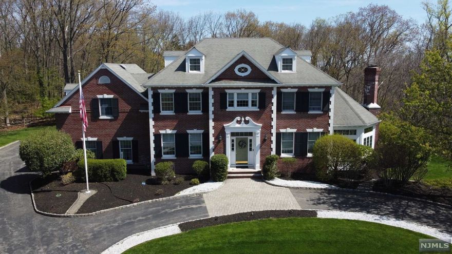 Majestic brick center hall colonial nestled in the most inconspicuous corner of town with magnificent NYC views awaits. This is your opportunity to own this impressive and expertly constructed custom Van Harken 5 bedroom 4 bath breathtaking home with aprox 5600 sq feet of meticulously maintained living space. Intricate craftsmanship adorns the entry foyer, living and dining room creating a royal yet welcoming place to call home. First floor has a grand kitchen open to the eating area, formal dining and sunken family room that is surrounded by windows and graced with a cozy gas fireplace. Full bath, laundry and mudroom complete the first floor. Second floor has 4 enormous bedrooms with ample closest space each, 5th bedroom is currently used as an office. Master bedroom is alternately accessible through a back staircase. Full finished basement has family area, bonus room, bar, full bath and workshop. 3 car attached garage. Mailing address is North Haledon, home is in Hawthorne.