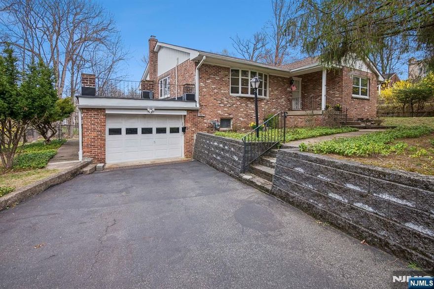 Lovely raised ranch-style home set on .47 acres at the top of a quiet dead-end street in beautiful Cedar Grove. This spacious home (3000sf +) offers privacy, generous living space, and incredible potential. The main level features 3 spacious bedrooms and one full bathroom, a large sun-filled living room with a beautiful bay window. A formal dining room that easily accommodates a full-size dining table, perfect for gatherings. The eat-in kitchen is generously sized and ready for your personal updates. Hardwood flooring runs throughout the main living areas, adding warmth & character. Split AC units provide cooling comfort on the first level. The expansive lower level which has a garage entrance offers exceptional additional living space, including a large rec room with built-in bar area, a second spacious bonus room with a convenient refreshment area including a sink, refrigerator, cabinetry, and countertop space, an additional full bathroom and a flexible room ideal for a home office or potential fourth bedroom. Additional highlights include an attached oversized one-car garage, basement replacement windows, newer Hot water heater and a newer roof (2022). Step outside to enjoy the incredible backyard and a wonderful terrace off the kitchen, the perfect place to relax. Commuters will appreciate NYC transportation at the corner of Briarhill & Ridge Road. Shops, restaurants & Montclair just minutes away. A rare opportunity to create your dream home in a sought-after location!