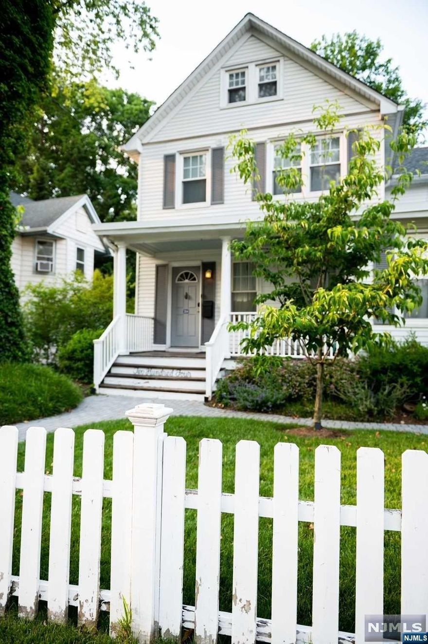Situated on a 50 x 200 manicured lot this updated residence boasts both a convenient in-town location and unparalleled privacy. A white picket fence and lemonade front porch greet you as you approach the home. The first floor is highlighted with gleaming hardwood floors, new kitchen, living room, large alcove, formal dining room, half bath, laundry and entry to the gorgeous yard. The second floor offers 3 generous sized bedrooms and a full bathroom. The third floor is finished, perfect as an office or play room. Classic lines and attention to detail enhance every room. The magnificent patios and gazebo offer summer solace, evening sunsets and the perfect setting for a grand celebration. Minutes to Bus, (across the street), rail service, stores, schools, shopping & Houses of Worship. Make it yours today!